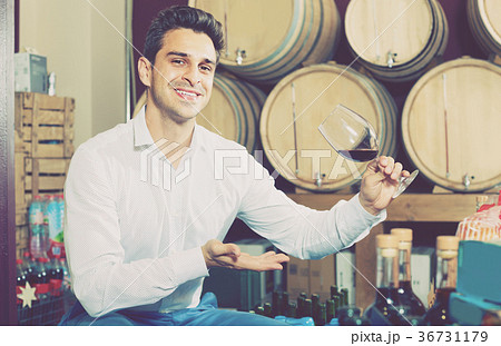 man tasting wine in cellar 36731179