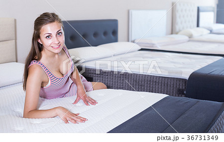 Adult woman looking new soft mattresses 36731349