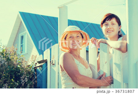 Two women near fence wicket 36731807