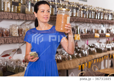 Woman choosing herbs and spices Woman choosing herbs and spices 36731885
