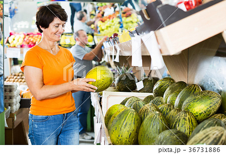 Woman choosing melon in store Woman choosing melon in store 36731886