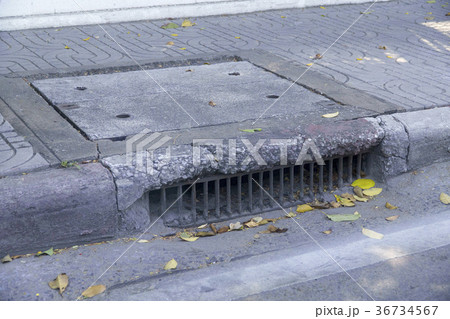 Water drainage old on the way and fallen leaves 36734567