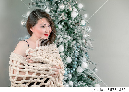 asian woman in shawl near the christmas tree asian woman in shawl near the christmas tree 36734825