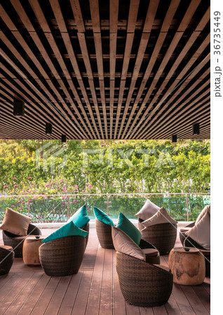 Resort lounge with wooden stools and blue pillow 36735449