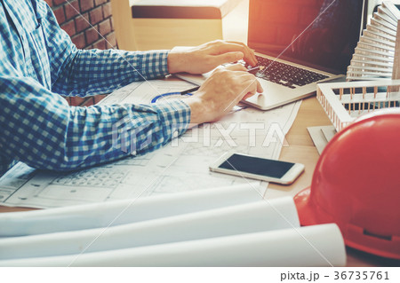 Architect or engineer working in office  blueprint 36735761