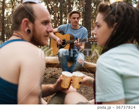 Friends guitar couple picnic party nature concept. 36737814