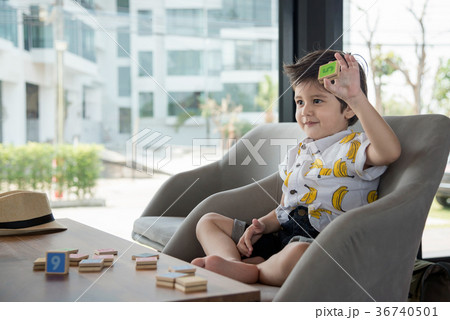 Asian Boy With Wooden Toy Plate Numbers. 36740501