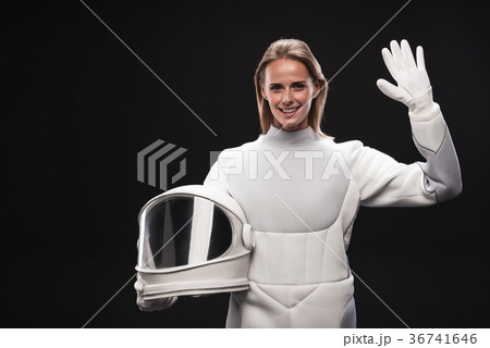 Cheerful lady cosmonaut is welcoming someone Cheerful lady cosmonaut is welcoming someone 36741646
