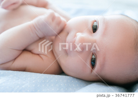 adorable newborn baby smiling lying on bed adorable newborn baby smiling lying on bed 36741777