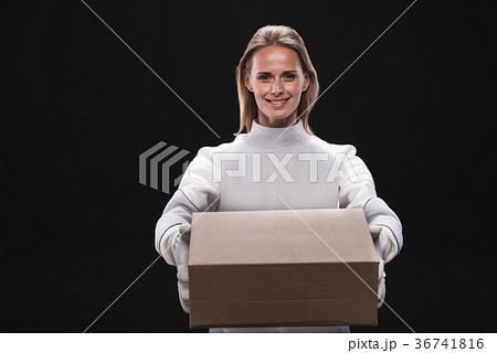 Optimistic happy woman astronaut is keeping carton 36741816