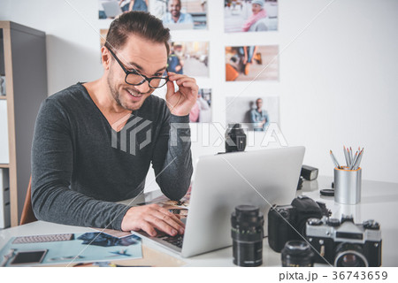 Outgoing retoucher working with laptop Outgoing retoucher working with laptop 36743659