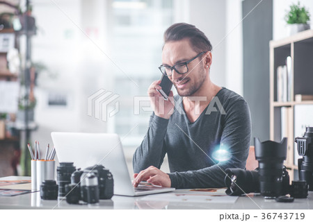 Cheerful man speaking by mobile at job Cheerful man speaking by mobile at job 36743719