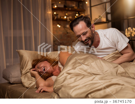 Cheerful man and woman bursting in laugh at home Cheerful man and woman bursting in laugh at home 36745170