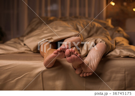 Legs of affectionate man and woman luxuriating on 36745175