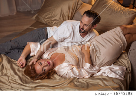 Cheerful loving couple resting on beddings 36745298