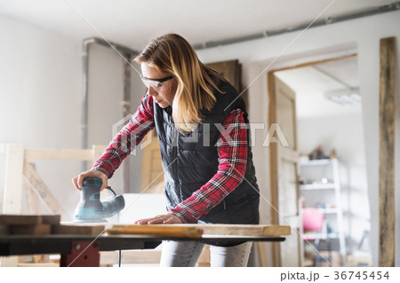 Young woman worker in the carpenter workroom. 36745454