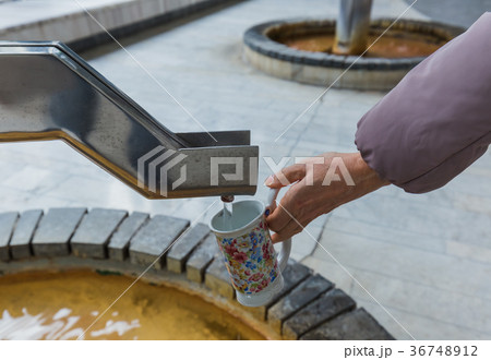 Tourist pours mineral water in Karlovy Vary Czech 36748912