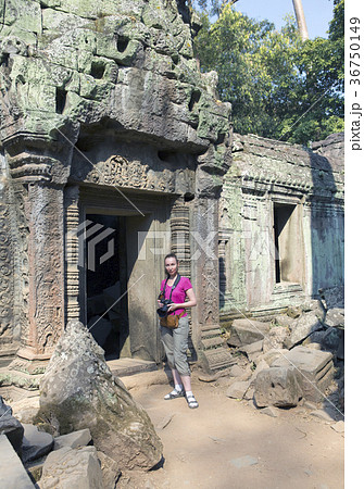 The woman the tourist with the camera at an entran The woman the tourist with the camera at an entran 36750149