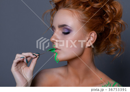Creative portrait of a beautiful woman with red hair. 36753391
