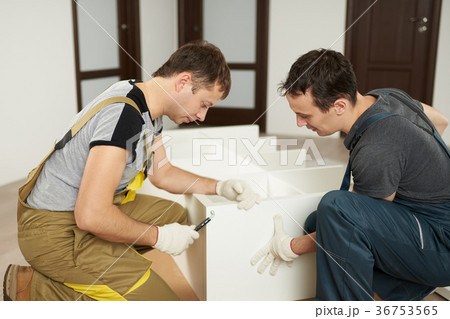 Two mans assembling furniture 36753565