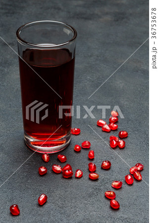 Pomegranate juice and seeds close-up on dark 36753678
