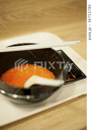 Satisfied meal left with an empty bowl. 36753780