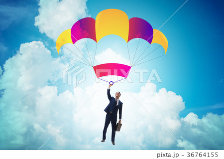 Young businessman falling on parachute in business 36764155