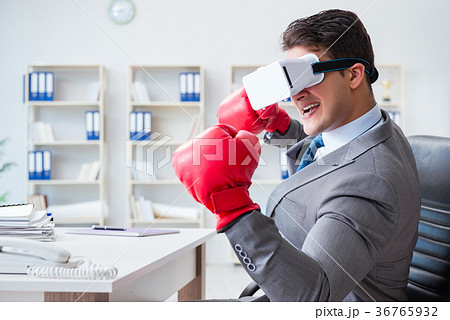 Man boxing in the office with virtual reality Man boxing in the office with virtual reality 36765932