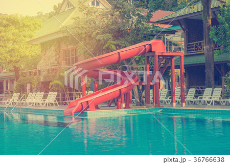 blue swimming pool with water slide at hotel 36766638