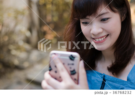 Close up of pretty Asian woman in the garden. Close up of pretty Asian woman in the garden. 36768232
