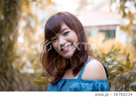 Close up of pretty Asian woman in the garden. 36768234