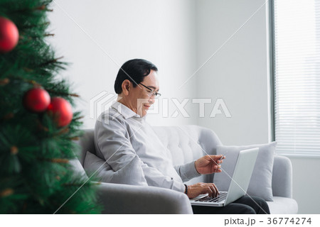 Senior asian man shopping using latop, credit card Senior asian man shopping using latop, credit card 36774274