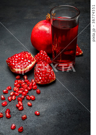 Pomegranate juice and seeds close-up on dark 36774551