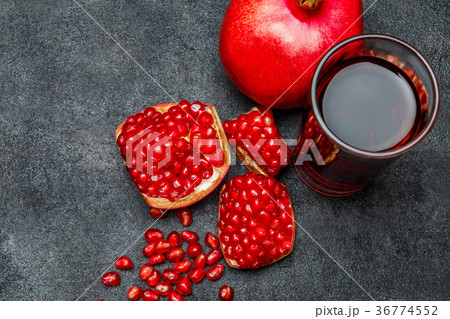 Pomegranate juice and seeds close-up on dark 36774552