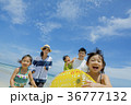 夏の海辺で浮輪を持って遊ぶ5人家族 36777132