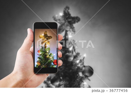 Taking photo of Christmas star, on Christmas tree 36777456
