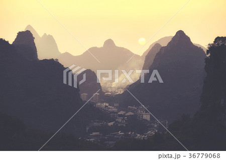 Scenic sunset over Karst mountains in China. Scenic sunset over Karst mountains in China. 36779068