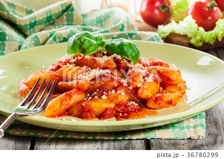 Italian gnocchi with tomato sauce and cheese 36780299