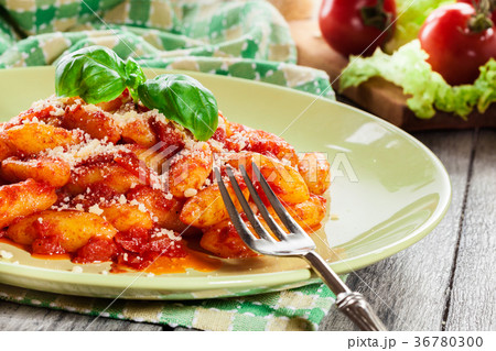 Italian gnocchi with tomato sauce and cheese Italian gnocchi with tomato sauce and cheese 36780300
