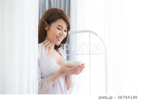 Morning woman in bed with coffee in her hand 36784180