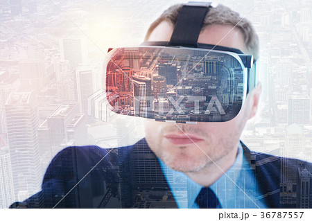 Close up of man in suit wearing VR headset 36787557