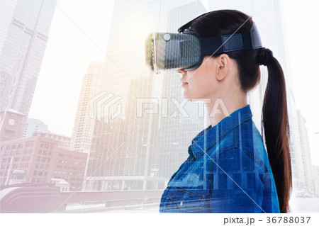 Side view of charming woman in VR headset 36788037