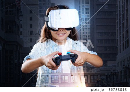 Smiling girl enjoying VR game with controller 36788818