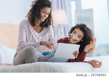 Positive minded girls smiling while looking at Positive minded girls smiling while looking at 36789002