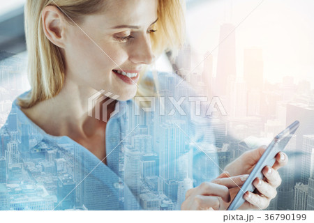 Pretty satisfied woman messaging and smiling. Pretty satisfied woman messaging and smiling. 36790199