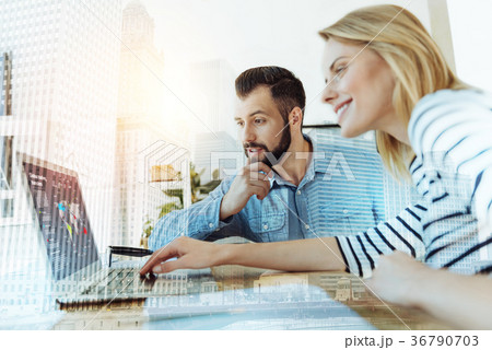 Couple of young perspective workers using laptop Couple of young perspective workers using laptop 36790703