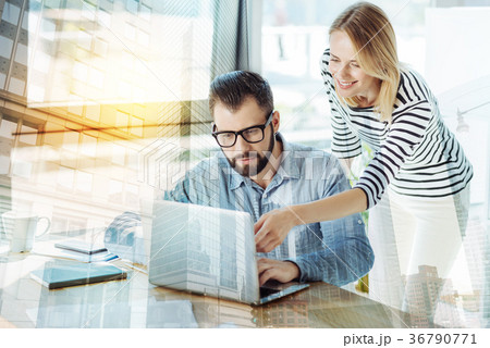 Stylish nice-looking colleagues working and using 36790771