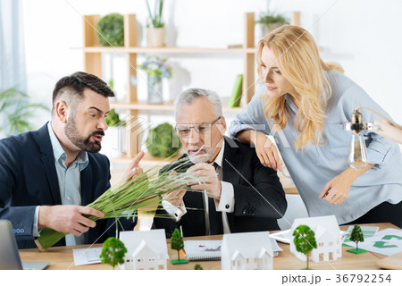 Curious colleagues touching a bunch of synthetic 36792254