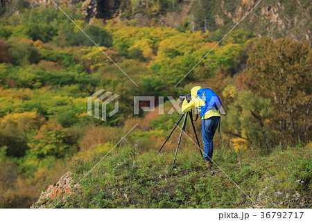 Photographer taking photo in beautiful nature Photographer taking photo in beautiful nature 36792717