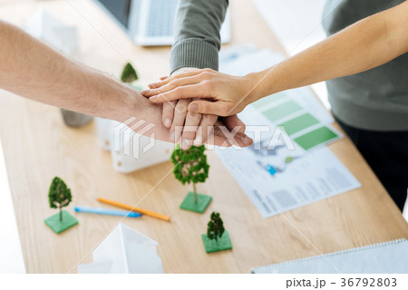 Friendly coworkers making a pyramid of hands after 36792803